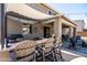Outdoor kitchen and bar area with seating, perfect for entertaining and enjoying backyard views at 21030 E Misty Ln, Queen Creek, AZ 85142