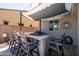 Outdoor kitchen with a built-in grill and barstool seating beneath a shaded canopy, perfect for entertaining at 21030 E Misty Ln, Queen Creek, AZ 85142