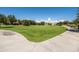 Lush green community park featuring open grassy field and walkway at 21030 E Misty Ln, Queen Creek, AZ 85142