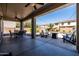 Expansive covered patio with seating, a lounge area, and a view of the landscaped backyard and pool at 21030 E Misty Ln, Queen Creek, AZ 85142
