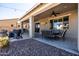 Spacious covered patio with an outdoor dining area and kitchen, perfect for enjoying outdoor living and entertaining at 21030 E Misty Ln, Queen Creek, AZ 85142
