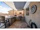 This covered outdoor kitchen features a built-in BBQ, a sink, bar seating, and a gas hookup at 21030 E Misty Ln, Queen Creek, AZ 85142