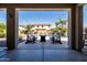 Covered patio with comfortable seating and a view of the pool and landscaped backyard at 21030 E Misty Ln, Queen Creek, AZ 85142