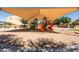 Playground with orange slides and green ladders under a sunshade canopy at 21030 E Misty Ln, Queen Creek, AZ 85142