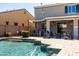 Outdoor living area features a pool and spa, lounge chairs, covered patio, and built-in BBQ at 21030 E Misty Ln, Queen Creek, AZ 85142