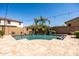 Beautiful backyard pool with palm trees and a stone waterfall feature creating a relaxing outdoor oasis at 21030 E Misty Ln, Queen Creek, AZ 85142