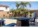 Relaxing outdoor area with a pool, stone waterfall, lush palm trees, and comfortable seating at 21030 E Misty Ln, Queen Creek, AZ 85142