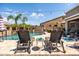 Relaxing poolside featuring lounge chairs, umbrellas, a water feature and mature tropical landscaping at 21030 E Misty Ln, Queen Creek, AZ 85142