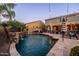 Beautiful backyard pool area with stone waterfalls and comfortable seating, perfect for outdoor entertainment and relaxation at 21030 E Misty Ln, Queen Creek, AZ 85142