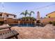 Sparkling pool with cascading water features and lush landscaping, perfect for a refreshing swim and relaxation at 21030 E Misty Ln, Queen Creek, AZ 85142
