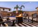 Backyard with a firepit and beautiful pool featuring cascading water features, perfect for a relaxing evening at 21030 E Misty Ln, Queen Creek, AZ 85142