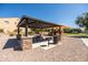 Community picnic area featuring a ramada with seating and grill, playground, and mature landscaping at 21030 E Misty Ln, Queen Creek, AZ 85142