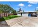 Expansive backyard boasting lush lawn, mature trees, a shed, and a covered parking area at 2321 W Claremont St, Phoenix, AZ 85015