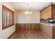 Cozy dining room featuring wood-look flooring and a classic chandelier at 2321 W Claremont St, Phoenix, AZ 85015