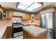 Bright kitchen featuring an island, stainless steel appliances, and ample cabinet space at 2321 W Claremont St, Phoenix, AZ 85015