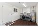 Well-lit laundry room with washer, dryer, utility sink and water heater at 2321 W Claremont St, Phoenix, AZ 85015