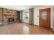 Inviting living room showcasing a brick fireplace and neutral tile flooring at 2321 W Claremont St, Phoenix, AZ 85015