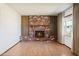 Spacious living room with a brick fireplace, tile flooring, and natural light at 2321 W Claremont St, Phoenix, AZ 85015
