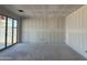 Open living area features fresh drywall, a ceiling cutout for lighting and sliding glass door at 24090 W Sunland Ave, Buckeye, AZ 85326