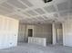 This expansive living room features bare walls and ceilings awaiting customization to your liking at 24090 W Sunland Ave, Buckeye, AZ 85326