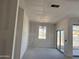 Spacious living room features fresh drywall and large sliding glass doors to the back patio at 24090 W Sunland Ave, Buckeye, AZ 85326