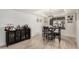 Bright dining area with tile floors and a modern chandelier, complemented by a stylish dark cabinet at 2602 W Summit Pl, Chandler, AZ 85224