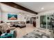 Spacious living room featuring stylish furniture, beamed ceilings, and seamless flow to the kitchen at 2602 W Summit Pl, Chandler, AZ 85224