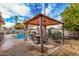 Covered patio featuring an outdoor dining set, perfect for entertaining by the beautiful pool area at 2602 W Summit Pl, Chandler, AZ 85224