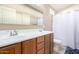 Well-lit bathroom featuring a double sink vanity and shower with curtain at 2725 E Mine Creek Rd # 2186, Phoenix, AZ 85024