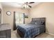 Comfortable bedroom with a ceiling fan, plaid bedspread and a golf print on the wall at 2725 E Mine Creek Rd # 2186, Phoenix, AZ 85024