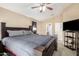 Bedroom featuring a large bed, a mounted TV and an attached bathroom at 2725 E Mine Creek Rd # 2186, Phoenix, AZ 85024