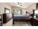 Bedroom with gray bedding, ceiling fan, dresser and natural light at 2725 E Mine Creek Rd # 2186, Phoenix, AZ 85024