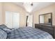 Bright bedroom featuring a large bed with a modern ceiling fan at 2725 E Mine Creek Rd # 2186, Phoenix, AZ 85024