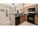 Kitchen with granite countertops, breakfast bar, and black appliances at 2725 E Mine Creek Rd # 2186, Phoenix, AZ 85024