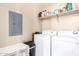 Functional laundry room equipped with storage shelves, washer, and dryer at 2725 E Mine Creek Rd # 2186, Phoenix, AZ 85024