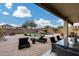 Inviting backyard featuring a sparkling pool, lush landscaping, and comfortable patio seating perfect for outdoor entertaining at 29437 W Columbus Ave, Buckeye, AZ 85396