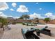 Resort-style backyard showcasing a beautiful pool, sun loungers, lush grass, and a serene outdoor space at 29437 W Columbus Ave, Buckeye, AZ 85396