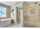 Bright bathroom with soaking tub, shower, and stylish fixtures at 29437 W Columbus Ave, Buckeye, AZ 85396