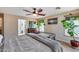 Bright, airy bedroom featuring ceiling fan, views to bathroom, and ample natural light at 29437 W Columbus Ave, Buckeye, AZ 85396