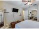 Bright bedroom with a ceiling fan, a TV, and a sliding closet with mirrored doors at 29437 W Columbus Ave, Buckeye, AZ 85396