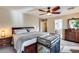 Comfortable bedroom featuring neutral walls, ceiling fan, and doorway to bath at 29437 W Columbus Ave, Buckeye, AZ 85396