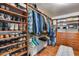 Organized walk-in closet with built-in shelving and hardwood floors, perfect for storage at 29437 W Columbus Ave, Buckeye, AZ 85396
