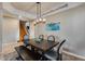 Lovely dining area featuring a dark wood table, staircase access, and neutral colors at 29437 W Columbus Ave, Buckeye, AZ 85396