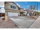 Two-story home with a two-car garage and xeriscaped front yard including desert plants and rocks at 29437 W Columbus Ave, Buckeye, AZ 85396