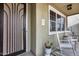 Welcoming front porch with a decorative security door and a rocking chair that enhances the curb appeal at 29437 W Columbus Ave, Buckeye, AZ 85396