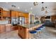 Spacious kitchen featuring a large island with granite countertops and seating, stainless steel appliances and breakfast nook at 29437 W Columbus Ave, Buckeye, AZ 85396