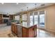 Open floor plan featuring a kitchen island with bar seating and sliding glass doors to backyard pool at 29437 W Columbus Ave, Buckeye, AZ 85396