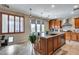 Gorgeous kitchen island with granite countertops, stainless steel appliances, and pendant lights at 29437 W Columbus Ave, Buckeye, AZ 85396