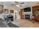 Comfortable living room area with a fireplace, tile floors, and built in cabinets and shelving at 29437 W Columbus Ave, Buckeye, AZ 85396