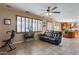 Relaxing living room with tile floors, shutters, and access to the kitchen at 29437 W Columbus Ave, Buckeye, AZ 85396